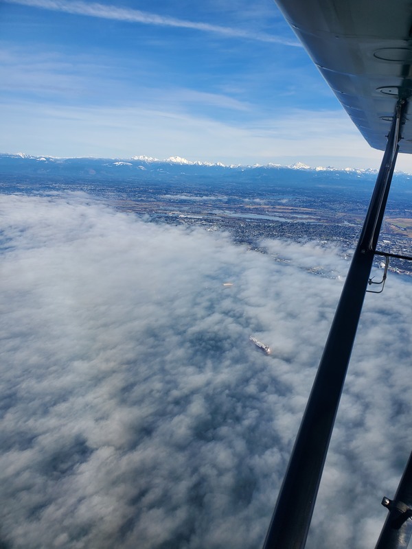 Photo of a low layer of
cottony clouds, then the city of Everett, then the Cascade mountains
for the background