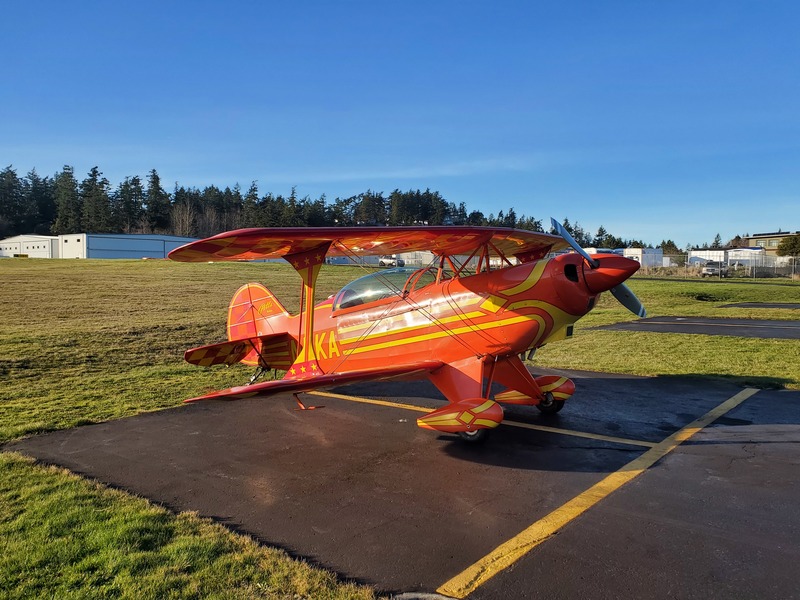 Photo of a bright orange
biplane with yellow accents